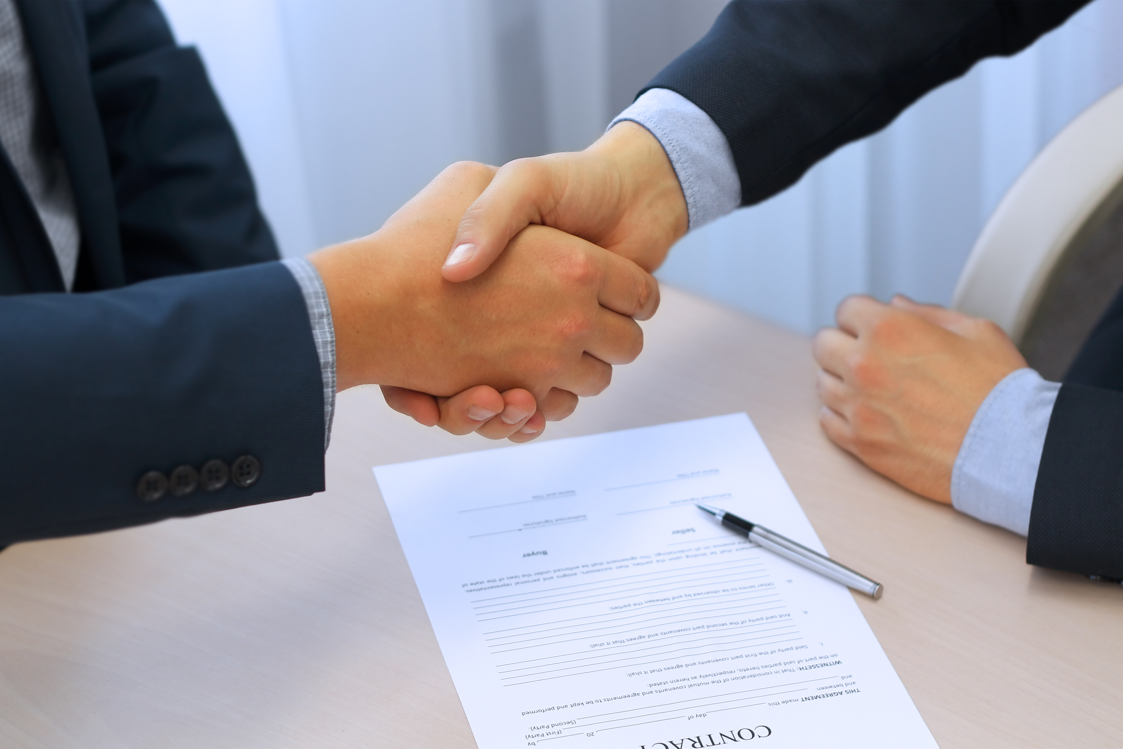 Close-up image of a firm handshake between two colleagues